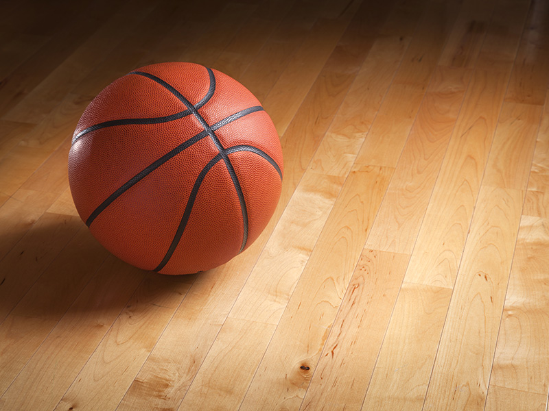 Basketball on Hardwood Floor